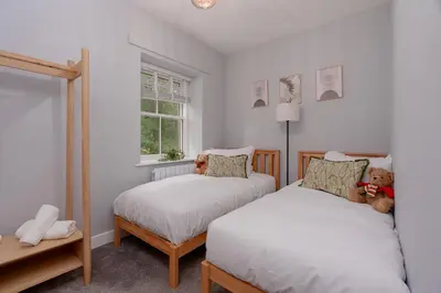 a bedroom with two beds and a window at Parson Castle View, Sleeps 6, Clitheroe Centre in Clitheroe