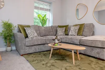 a living room with a couch and a table at Parson Castle View, Sleeps 6, Clitheroe Centre in Clitheroe