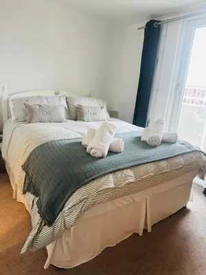 a bedroom with a bed with two pillows on it at Liverpool City Centre Apartment with view in Liverpool