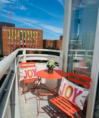 a balcony with a table and chairs on a balcony at Liverpool City Centre Apartment with view in Liverpool