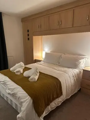 a bedroom with a large bed with towels on it at Liverpool City Centre Apartment with view in Liverpool