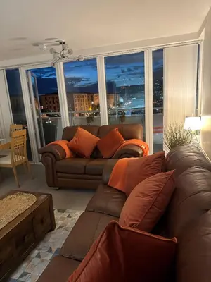 a living room with a couch and a large window at Liverpool City Centre Apartment with view in Liverpool