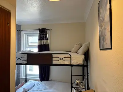 two bunk beds in a room with a window at Affordable Golden Mile Hotel In Blackpool Close To The Beach And Blackpool City Centre With Free Street Parking Subject To Availabilty in Blackpool