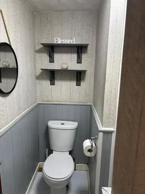 a small bathroom with a white toilet and shelves at Affordable Golden Mile Hotel In Blackpool Close To The Beach And Blackpool City Centre With Free Street Parking Subject To Availabilty in Blackpool