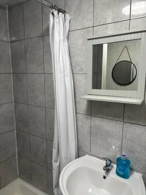 a bathroom with a shower curtain and a sink at Affordable Golden Mile Hotel In Blackpool Close To The Beach And Blackpool City Centre With Free Street Parking Subject To Availabilty in Blackpool