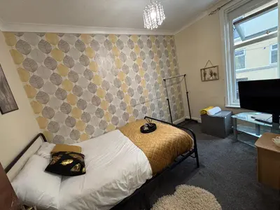 a bedroom with a bed in a room with a television at Affordable Golden Mile Hotel In Blackpool Close To The Beach And Blackpool City Centre With Free Street Parking Subject To Availabilty in Blackpool