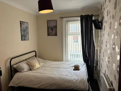 a bed in a room with a window and a bed sidx sidx sidx at Affordable Golden Mile Hotel In Blackpool Close To The Beach And Blackpool City Centre With Free Street Parking Subject To Availabilty in Blackpool