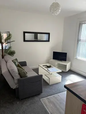 a living room with a couch and a tv at Central Location 1 Double Bedroom Apartment 7 in Blackpool