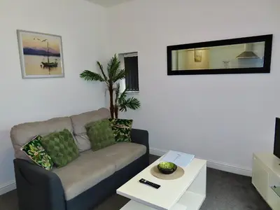 a living room with a couch and a table at Central Location 1 Double Bedroom Apartment 7 in Blackpool