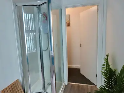a glass shower in a room with a hallway at Central Location 1 Double Bedroom Apartment 7 in Blackpool