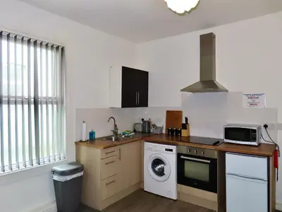 a kitchen with a sink and a washing machine at Central Location 1 Double Bedroom Apartment 7 in Blackpool