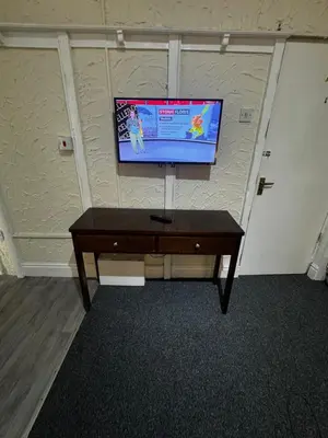 a flat screen tv on a wall in a room at Ground Floor Cute & Cozy - 1 Person Studio - South Pier in Blackpool