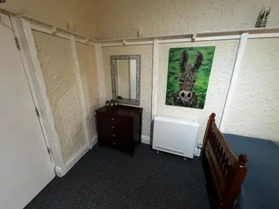 a room with a painting of a donkey on the wall at Ground Floor Cute & Cozy - 1 Person Studio - South Pier in Blackpool