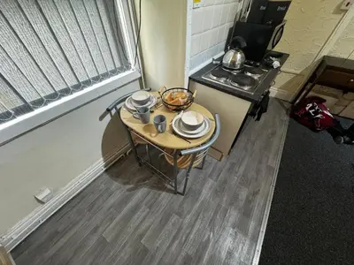 a small table in a kitchen with a sink at Ground Floor Cute & Cozy - 1 Person Studio - South Pier in Blackpool