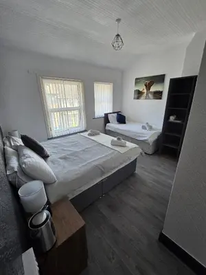 a bedroom with a large bed and a couch at The Lynbar Hotel in Blackpool