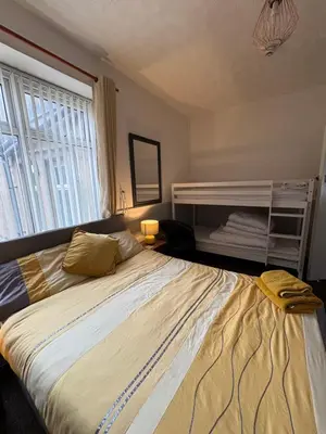 a bedroom with a large bed and a window at The Lynbar Hotel in Blackpool