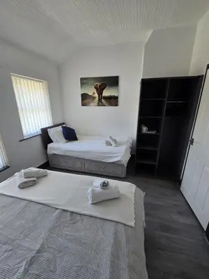 a hotel room with two beds and a window at The Lynbar Hotel in Blackpool