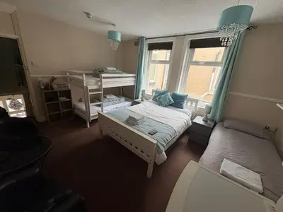 a small room with a bed and a desk at The Lynbar Hotel in Blackpool
