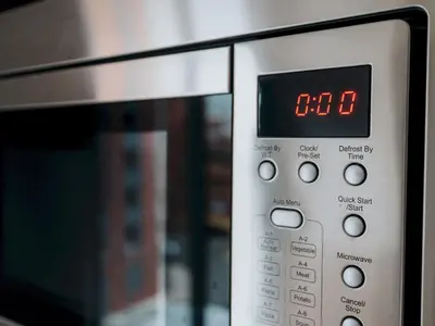 a microwave oven with a digital clock on it at Pass the Keys Stylish Flat Near Moorfields Stn in Liverpool