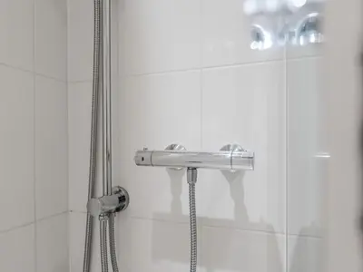 a shower with a faucet in a bathroom at Pass the Keys Stylish Flat Near Moorfields Stn in Liverpool