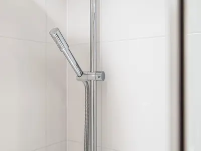 a shower with a chrome shower head in a bathroom at Pass the Keys Stylish Flat Near Moorfields Stn in Liverpool