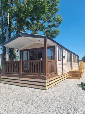 a cabin with a porch and awning at Leafy Lytham Holiday Home in Warton