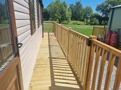 a wooden walkway on a porch of a house at Leafy Lytham Holiday Home in Warton