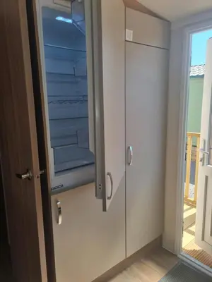 a glass cabinet in a room with a door at Leafy Lytham Holiday Home in Warton