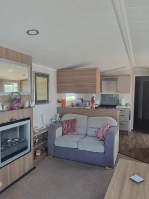 a living room with a couch and a television at Leafy Lytham Holiday Home in Warton
