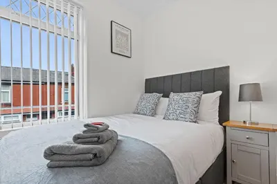 a bedroom with a bed with towels on it at Stylish 4 Bed House In Chorley in Chorley