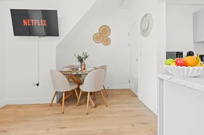 a kitchen and dining room with a table and chairs at Stylish 4 Bed House In Chorley in Chorley