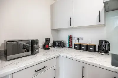 a kitchen with a counter top with a microwave at Stylish 4 Bed House In Chorley in Chorley