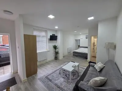 a living room with a couch and a bed at Preston Studio Flat in Preston