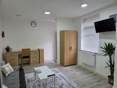 a living room with a desk and a desk sidx sidx sidx sidx sidx at Preston Studio Flat in Preston