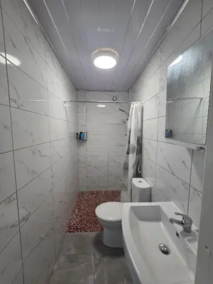 a white bathroom with a toilet and a sink at Preston Studio Flat in Preston
