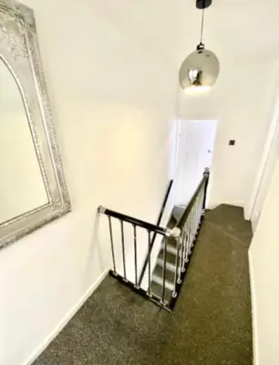 a stairway with a mirror and a stair case at stay anfield in Liverpool