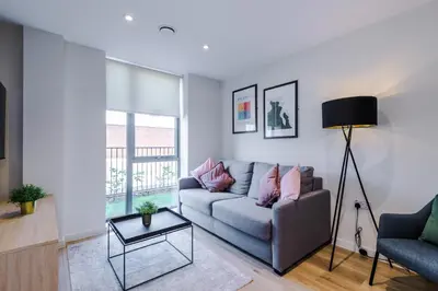 a living room with a couch and a table at High End 2 Bedroom with Parking and City Access in Liverpool