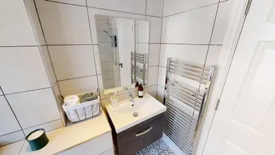 a bathroom with a sink and a mirror at Cathedral Views Heart of City Communal Laundry in Liverpool