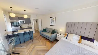 a living room with a bed and a kitchen at Cathedral Views Heart of City Communal Laundry in Liverpool