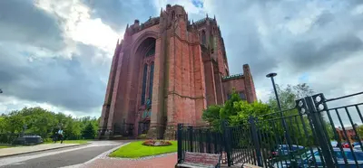 a large brick building with a bench in front of it at Cathedral Views Heart of City Communal Laundry in Liverpool