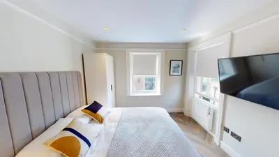 a bedroom with a bed and a flat screen tv at Cathedral Views Heart of City Communal Laundry in Liverpool
