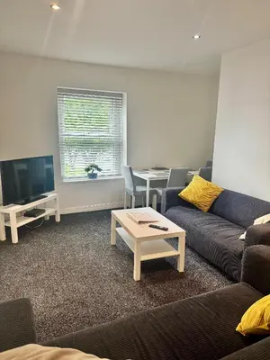 a living room with a couch and a table at The Valley View Apartment in Great Harwood