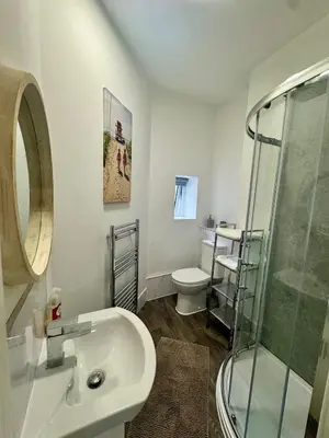 a bathroom with a sink and a shower and a toilet at The Valley View Apartment in Great Harwood
