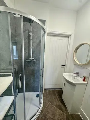 a bathroom with a shower and a sink at The Valley View Apartment in Great Harwood