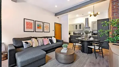 a living room with a couch and a table at Stylish Baltic Apt II, Parking, Sleeps 6! in Liverpool