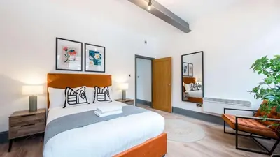 a bedroom with a large bed in a room at Stylish Baltic Apt II, Parking, Sleeps 6! in Liverpool