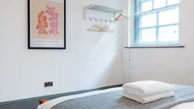 a bedroom with a bed with two towels on it at Stylish Baltic Apt II, Parking, Sleeps 6! in Liverpool