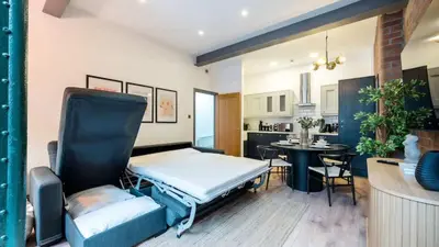 a room with a bed and a dining room at Stylish Baltic Apt II, Parking, Sleeps 6! in Liverpool