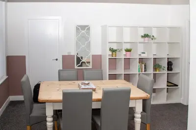 a dining room with a wooden table and chairs at Santiago 3 in Southport