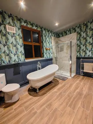 a large bathroom with a tub and a shower at Casa Rocío in Liverpool